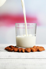 Almond milk is poured into glass,