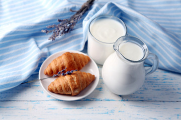 Homemade yogurt in jug and tasty croissants