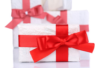 Beautiful gifts with red ribbons, isolated on white