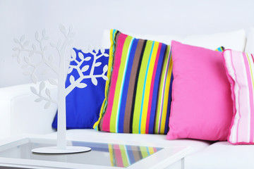 White sofa with colorful pillows in room