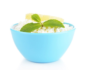 Bowl of tasty cottage cheese with pineapple, isolated on white
