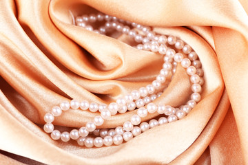Beautiful pearls on golden silk cloth