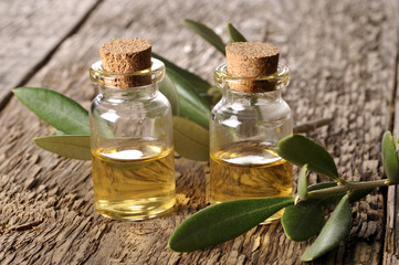 spa oil with leaves on a wooden table