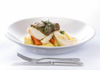Cod fish on potato mash with vegetables