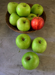 green apples and a red apple