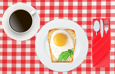 Scrambled eggs with bread on plate on color napkin and coffee cu