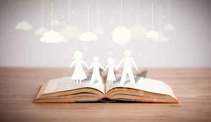 Cardboard figures of the family on opened book