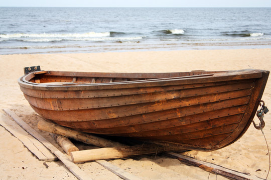 The wooden boat on the seashore