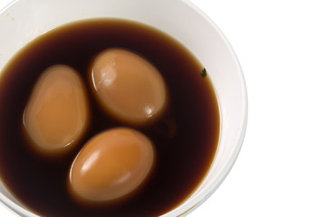 Stewed eggs in cups on white.