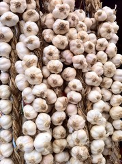 Strings of garlic at market