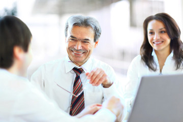 Successful businessteam of three sitting in office