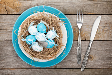 Easter eggs nest on plate
