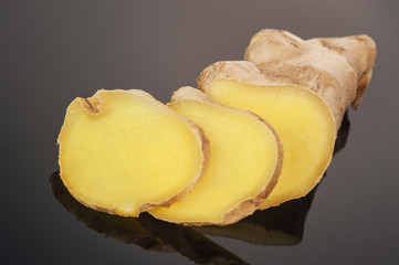 Root Ginger sliced on dark background