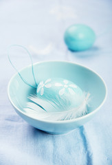 blue easter eggs with white  feather