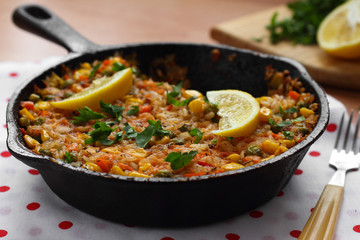 Vegetable paella with corn and green peas