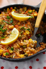 Vegetable paella with corn and green peas