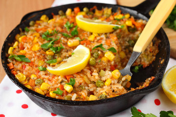Vegetable paella with corn and green peas