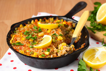 Vegan paella with corn and green peas