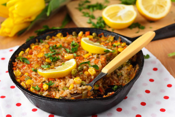 Vegan paella with corn and green peas