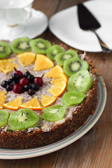 Healthy raw vegan cake with fruits, berries and coconut