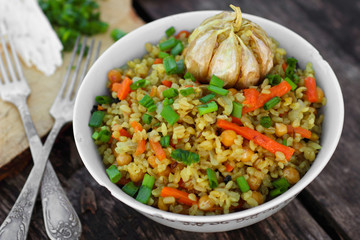 Asian vegetarian bulgur pilaf with chickpeas, carrots and garlic