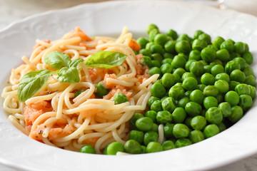 Vegan meal. Pasta with tomato sauce and green peas