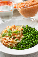 Healthy Vegan meal. Pasta with tomato sauce and green peas