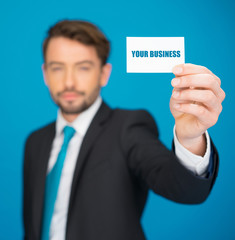 handsome businessman showing blank business card