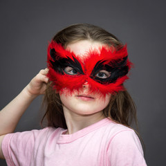 Young girl in carnival mask