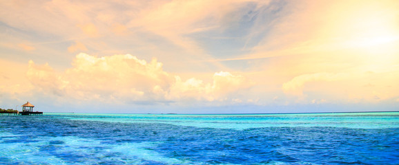 Maldives bungalows sunset panorama