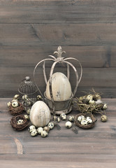 vintage easter decoration with eggs, nest and birdcage