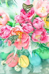 pink tulip flowers, butterflies and colored eggs