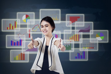 Pleased businesswoman giving thumbs up 1