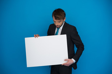 Businessman holding blank poster