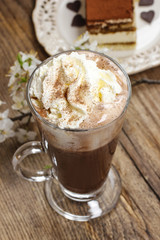 Irish coffee on wooden table. Tiramisu cake