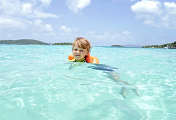 Child Swimming in Tropical Ocean