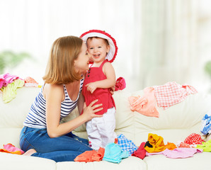 happy  Mother and baby girl with clothes ready for traveling on