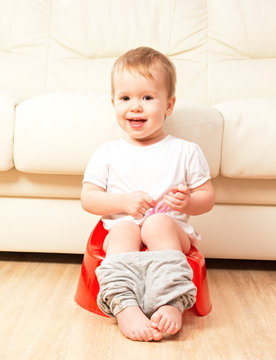 Baby Sitting On Potty In Toilet