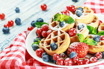 Waffles with fresh berries on the table