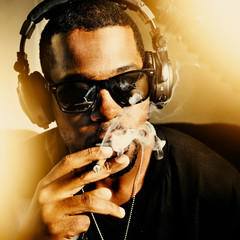 cool african man smoking joint wearing headphones