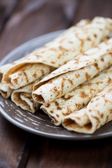 Rolled pancakes with stuffing, vertical shot, close-up