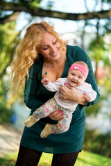 Young mom with baby in park