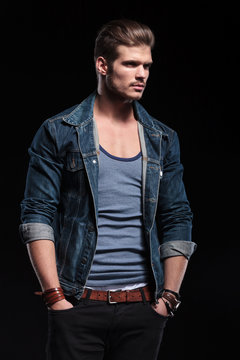 young fashion man in casual jeans clothes looking away