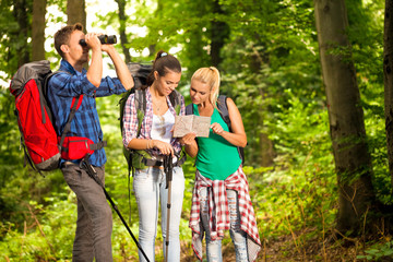 group of hikers with map and binoculars