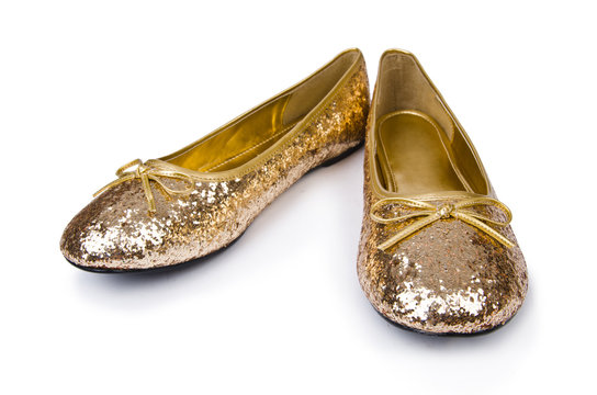 Golden ballet shoes isolated on white