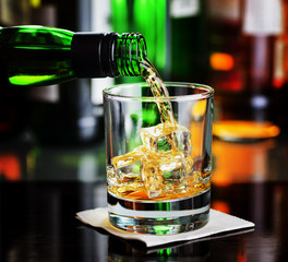 Whiskey pouring a glass in a bar