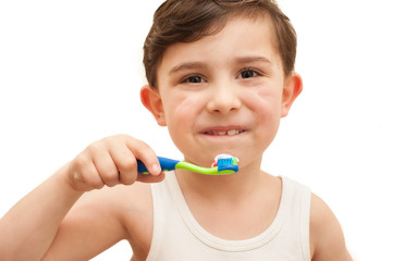 Child brushing teeth isolated