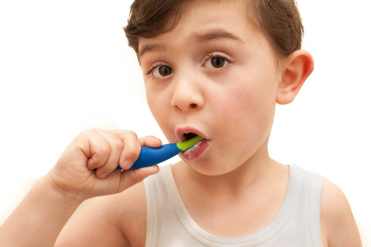 Young boy brushing teeth isolated