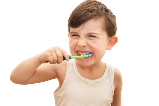Boy brushing teeth isolated