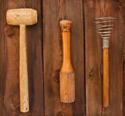 Old kitchen utensils on a wooden background